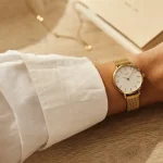Montres en or pour femme : cadran noir et bracelet maille dorée